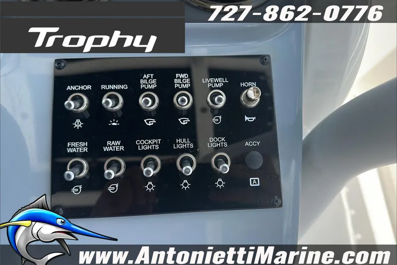 Slide: The Image of Control panel of 2025 Trophy T24 CC boat with various switches and marine branding. - 16