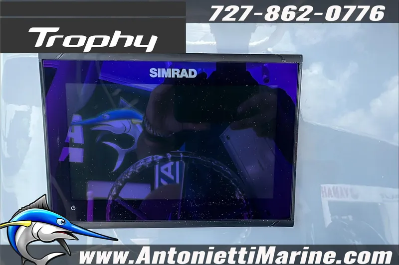Slide: The Image of Trophy T24 CC 2025 boat display with Simrad screen, contact info, and website. - 18