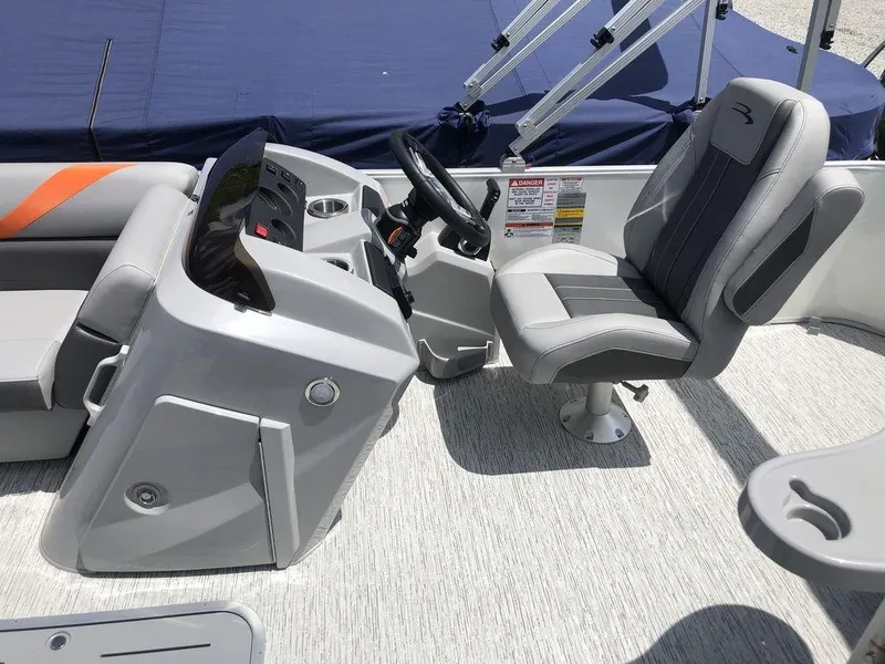 Slide: The Image of 2025 Bennington SX L-Bench 22 SXL boat interior with steering console and seating. - 6