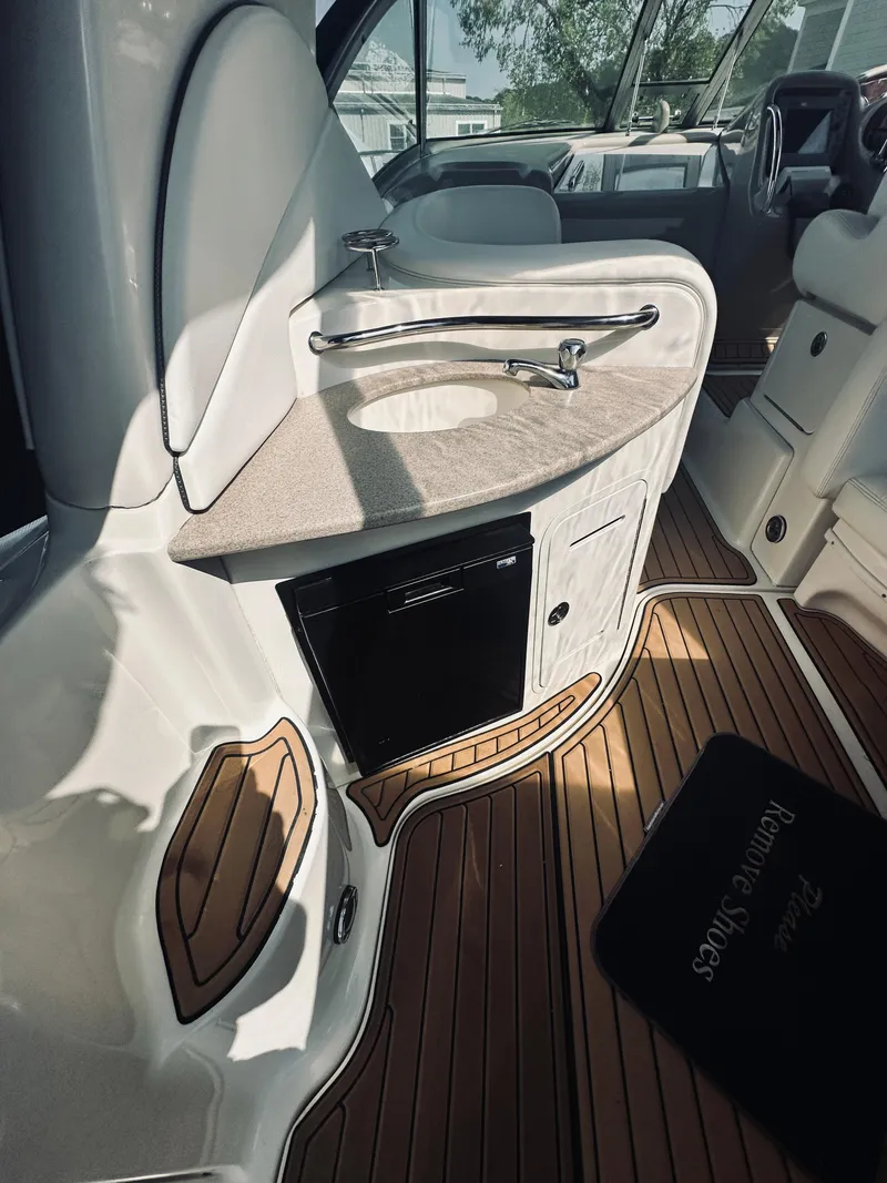 Slide: The Image of 2006 Sea Ray 320 Sundancer interior with sink and wooden flooring. - 10