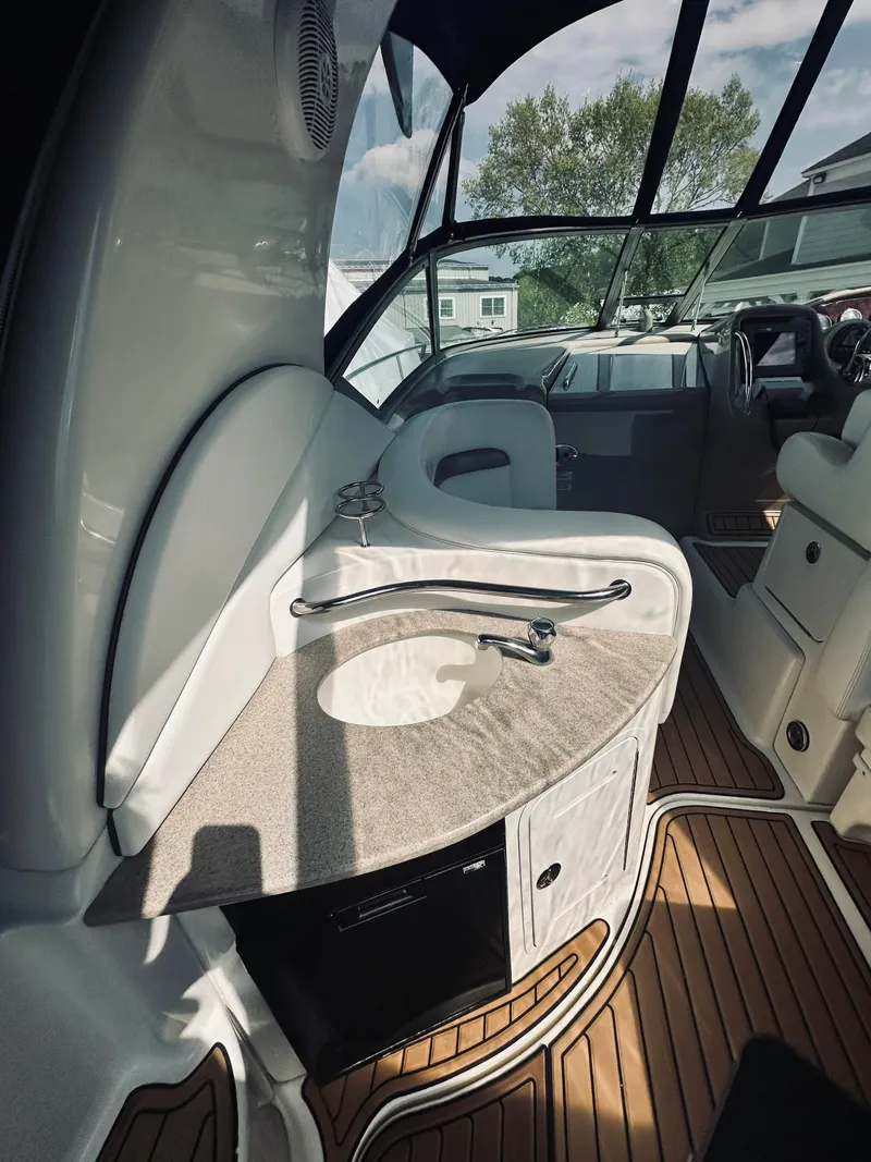 Slide: The Image of 2006 Sea Ray 320 Sundancer interior with sleek design and wooden flooring. - 12