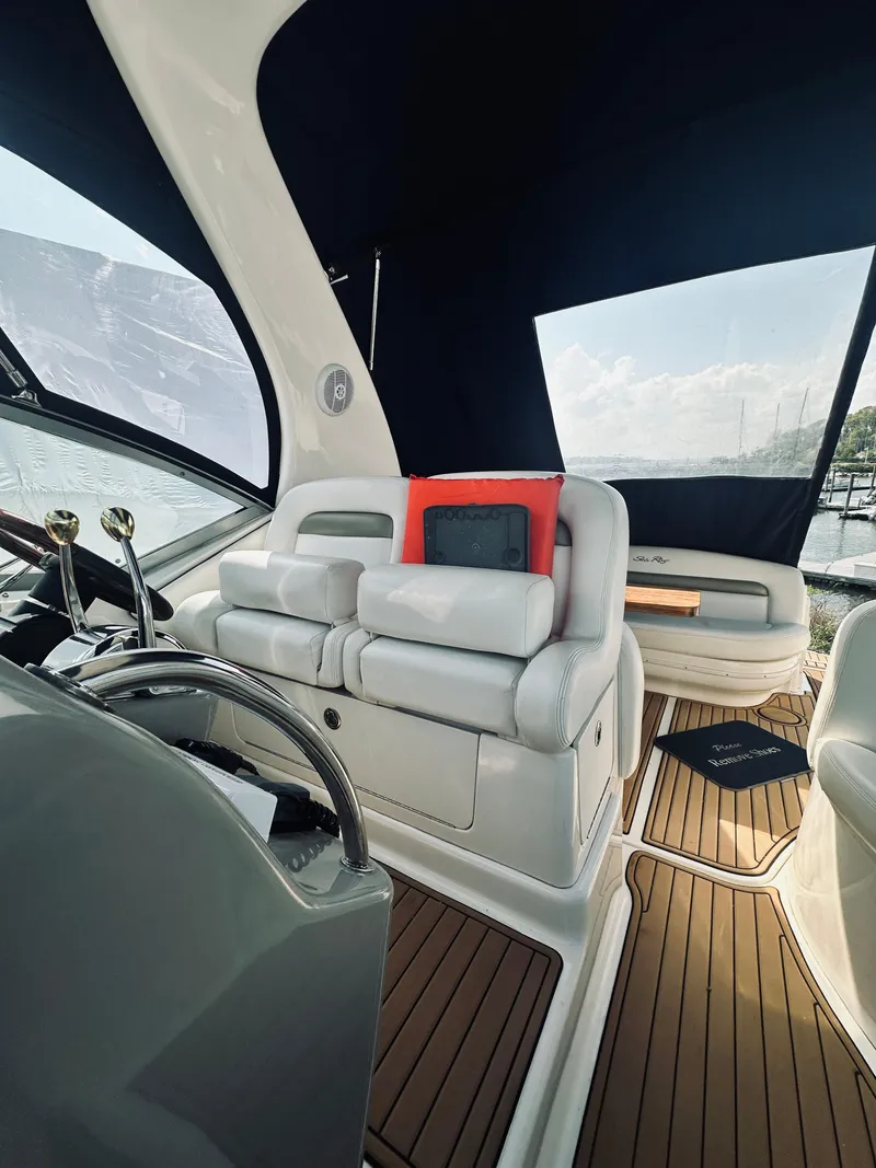 Slide: The Image of Interior of 2006 Sea Ray 320 Sundancer yacht with luxurious seating and modern controls. - 16