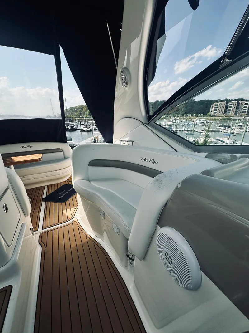 Slide: The Image of 2006 Sea Ray 320 Sundancer interior with sleek seating and marina view. - 17