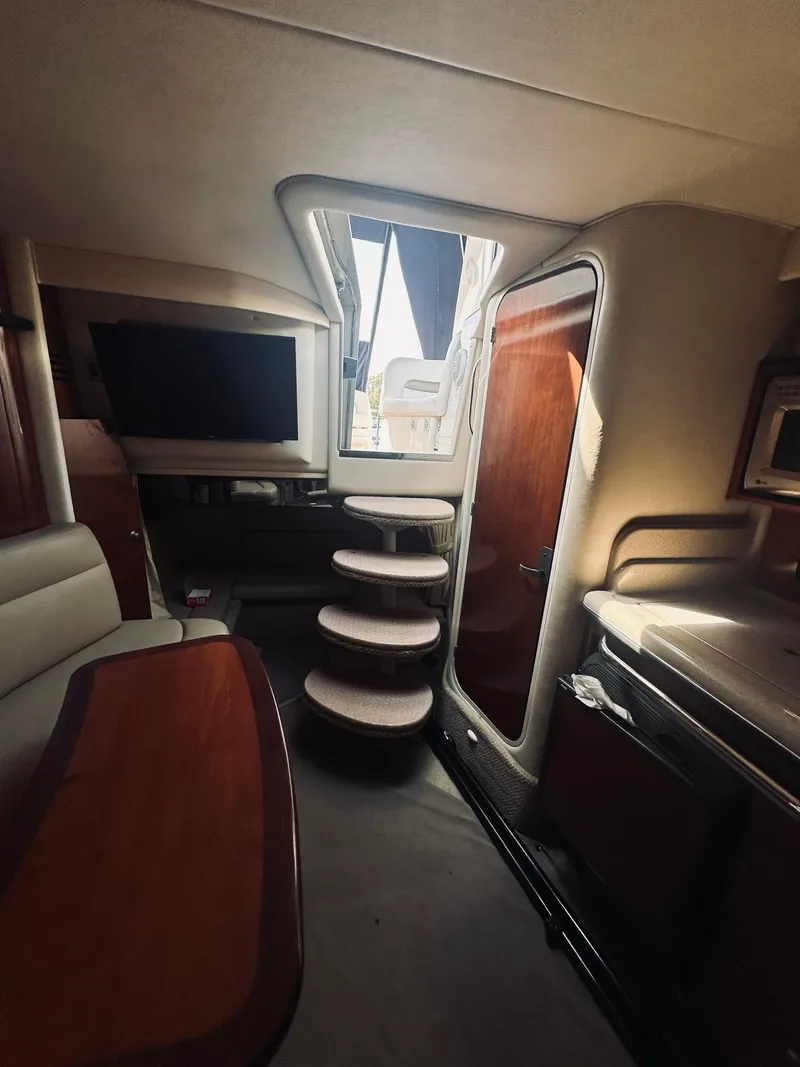 Slide: The Image of Interior of 2006 Sea Ray 320 Sundancer yacht with stairs, TV, and kitchenette. - 19