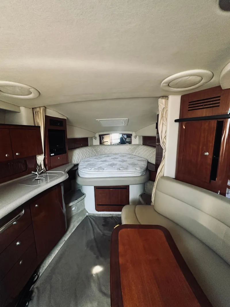Slide: The Image of Interior of 2006 Sea Ray 320 Sundancer with bed, kitchenette, and seating area. - 20