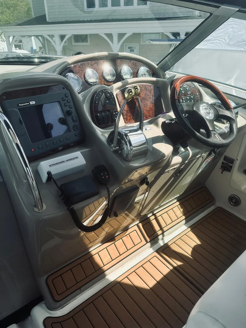 Slide: The Image of Helm of 2006 Sea Ray 320 Sundancer with wood accents and modern controls. - 26