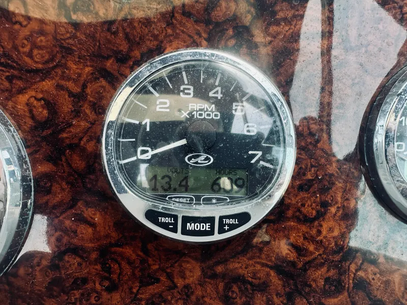 Slide: The Image of Close-up of a 2006 Sea Ray 320 Sundancer RPM gauge on a wood-patterned dashboard. - 28
