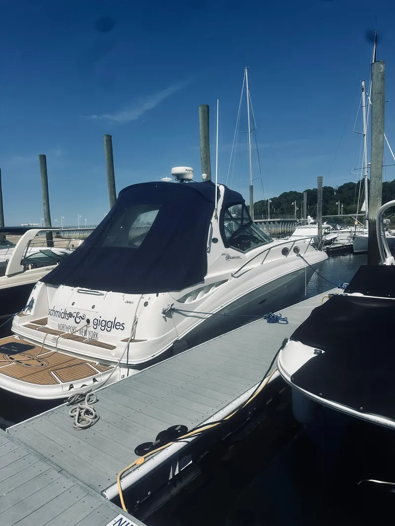 Slide: The Image of 2006 Sea Ray 320 Sundancer docked at a marina under clear blue skies. - 3
