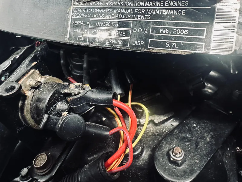 Slide: The Image of Engine components of a 2006 Sea Ray 320 Sundancer, featuring wiring and specifications label. - 30