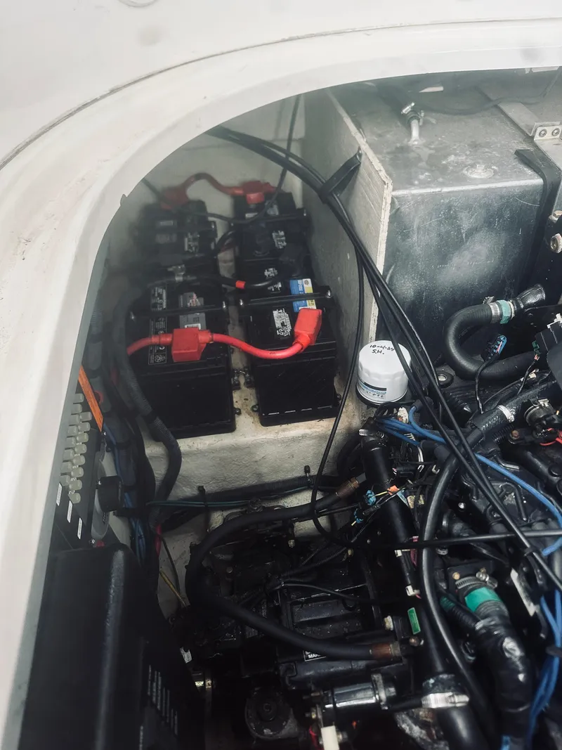 Slide: The Image of Engine compartment of a 2006 Sea Ray 320 Sundancer with visible batteries and wiring. - 32