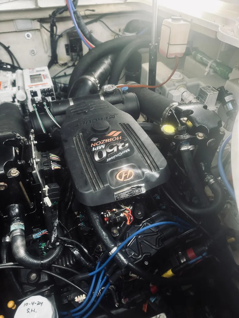 Slide: The Image of Engine compartment of a 2006 Sea Ray 320 Sundancer boat, showcasing detailed components. - 34