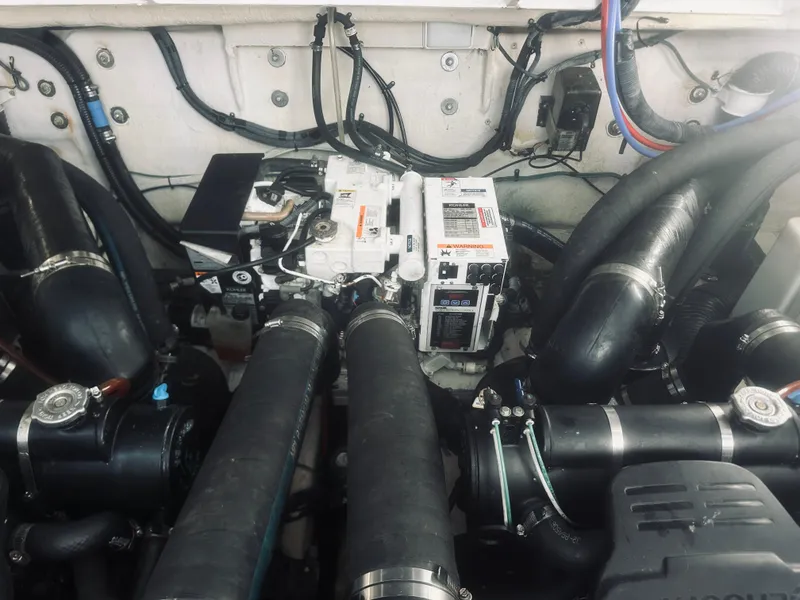 Slide: The Image of Engine compartment of a 2006 Sea Ray 320 Sundancer with visible components and wiring. - 35