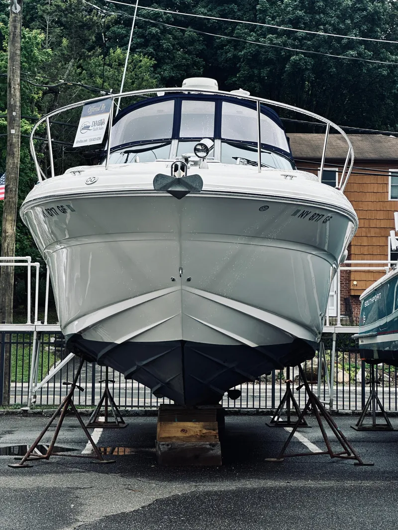 Slide: The Image of 2006 Sea Ray 320 Sundancer boat on stands, front view, outdoors. - 37