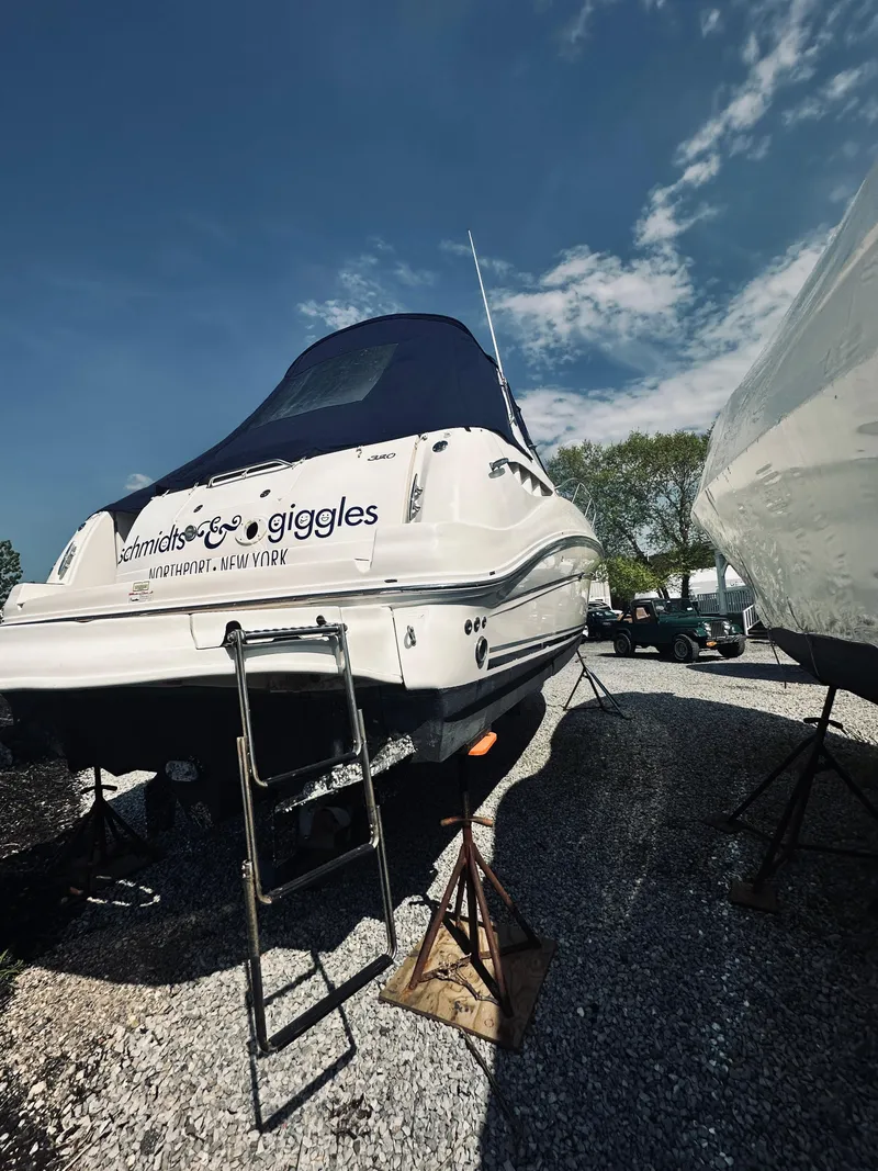 Slide: The Image of 2006 Sea Ray 320 Sundancer boat on stands under a clear blue sky. - 7