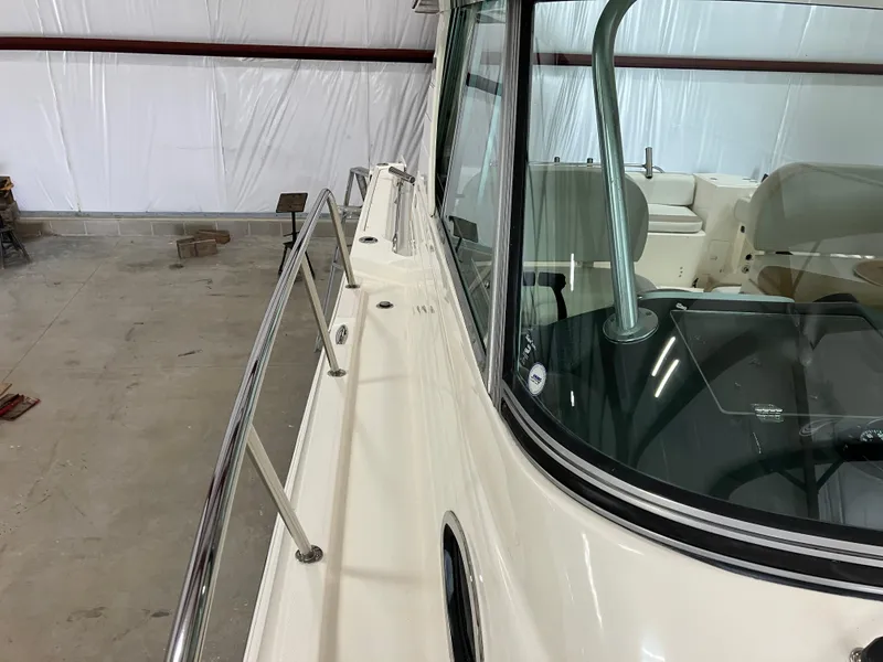 Slide: The Image of 2012 Striper 2901 Walkaround I/O boat in storage, showcasing deck and cabin area. - 11