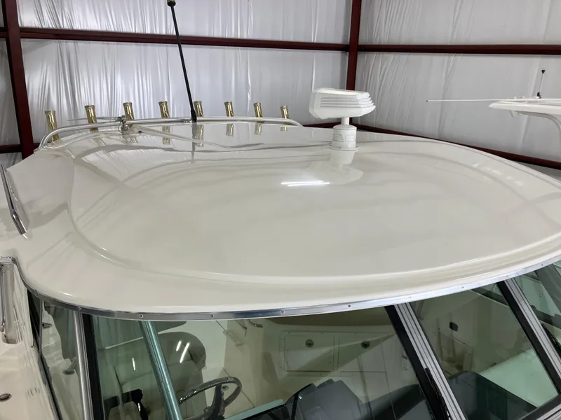 Slide: The Image of 2012 Striper 2901 Walkaround I/O boat roof with radar and rod holders. - 12