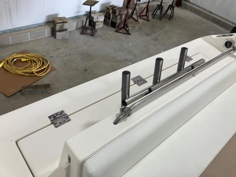 Slide: The Image of 2012 Striper 2901 Walkaround I/O boat deck with rod holders in a garage. - 20