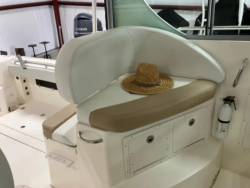 Slide: The Image of 2012 Striper 2901 Walkaround I/O boat interior with seating and a straw hat. - 23