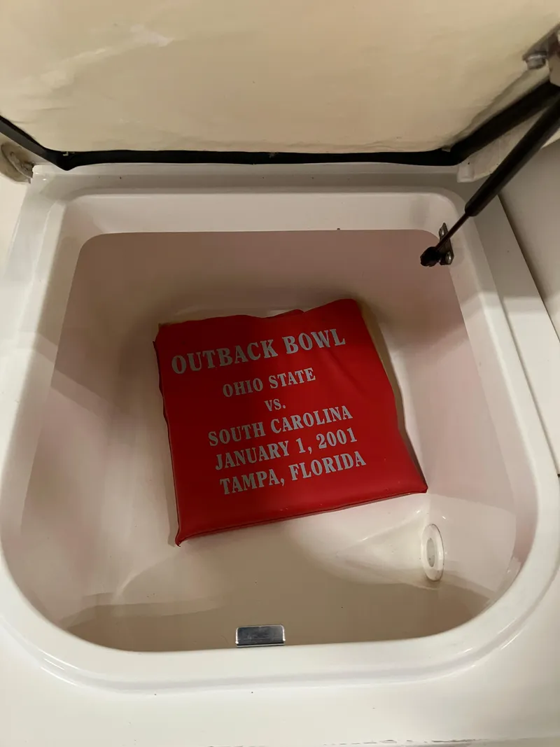 Slide: The Image of 2012 Striper 2901 Walkaround I/O storage compartment with Outback Bowl cushion. - 24