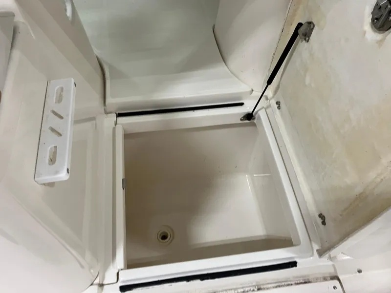 Slide: The Image of Open storage compartment on 2012 Striper 2901 Walkaround I/O boat. - 28
