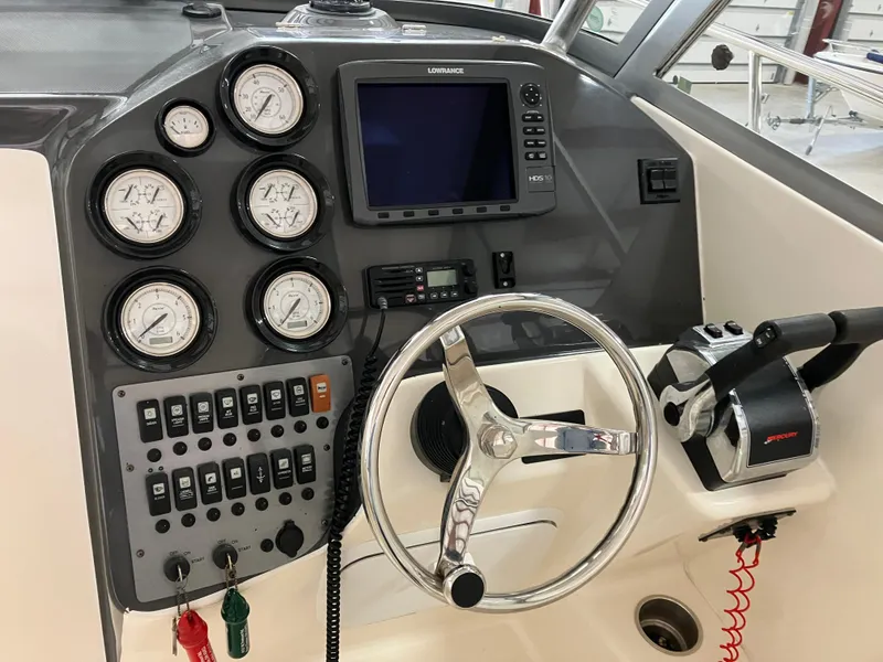 Slide: The Image of 2012 Striper 2901 Walkaround I/O dashboard with gauges, steering wheel, and controls. - 30
