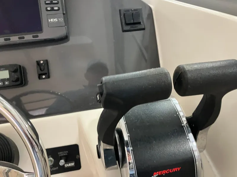 Slide: The Image of 2012 Striper 2901 Walkaround I/O boat controls with Mercury throttle and navigation equipment. - 32