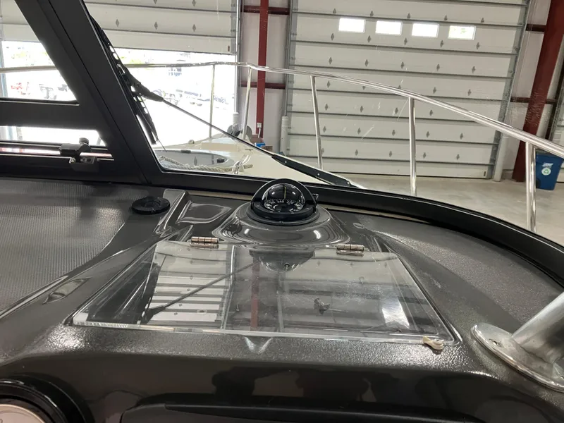Slide: The Image of 2012 Striper 2901 Walkaround I/O boat dashboard with compass in a garage setting. - 33