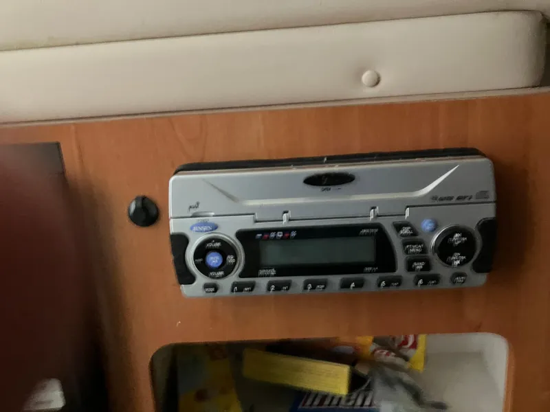 Slide: The Image of 2012 Striper 2901 Walkaround I/O cabin stereo system with wood paneling. - 37