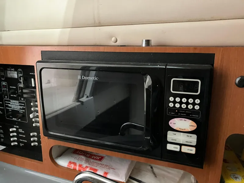 Slide: The Image of Dometic microwave in 2012 Striper 2901 Walkaround I/O boat interior. - 38