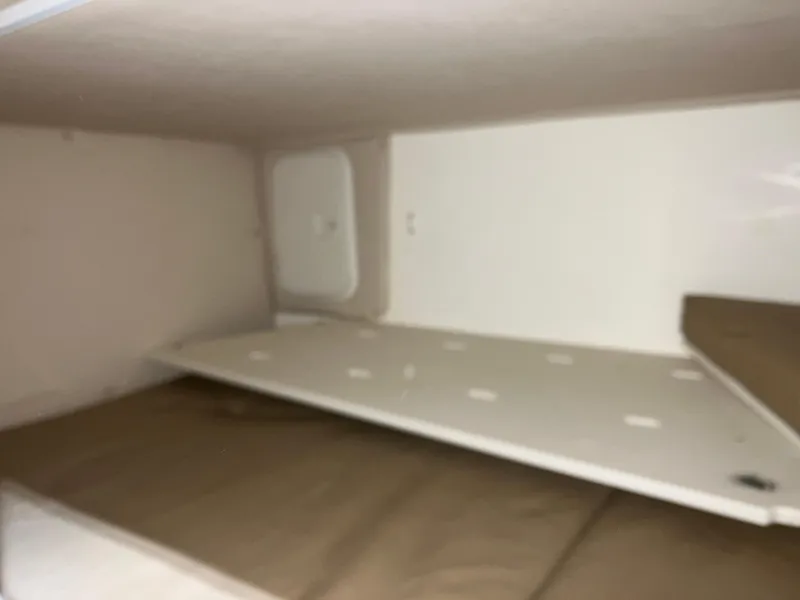 Slide: The Image of Interior cabin of 2012 Striper 2901 Walkaround I/O boat, featuring a compact sleeping area. - 42