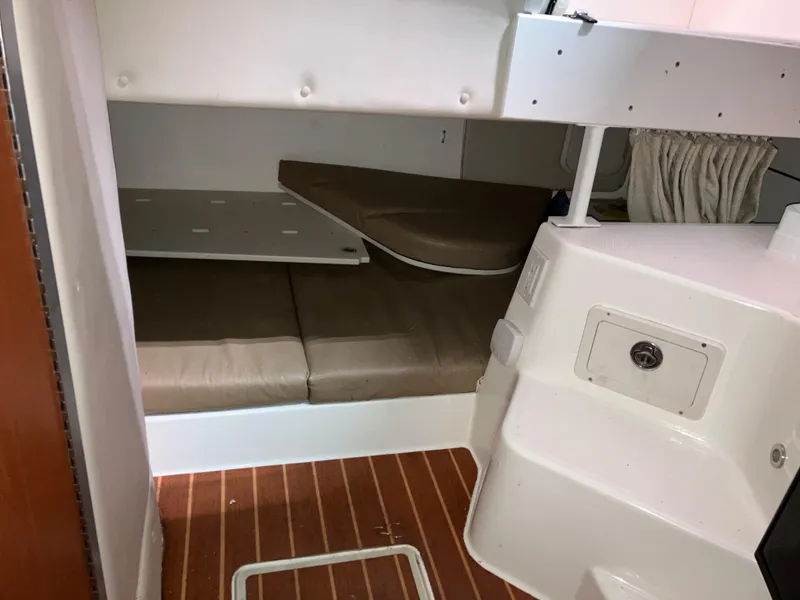 Slide: The Image of 2012 Striper 2901 Walkaround I/O cabin interior with cushioned seating and wood flooring. - 43
