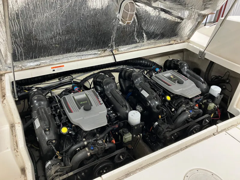 Slide: The Image of Twin engines in a 2012 Striper 2901 Walkaround I/O boat engine compartment. - 46