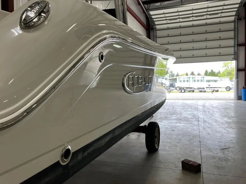 Slide: The Image of 2012 Striper 2901 Walkaround I/O boat in a garage, side view. - 5