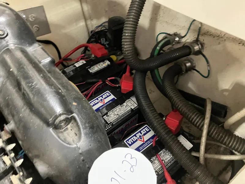 Slide: The Image of 2012 Striper 2901 Walkaround I/O engine compartment with batteries and wiring. - 50