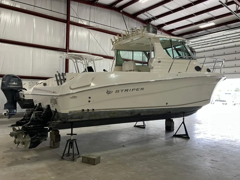 Slide: The Image of 2012 Striper 2901 Walkaround I/O boat in indoor storage on stands. - 6