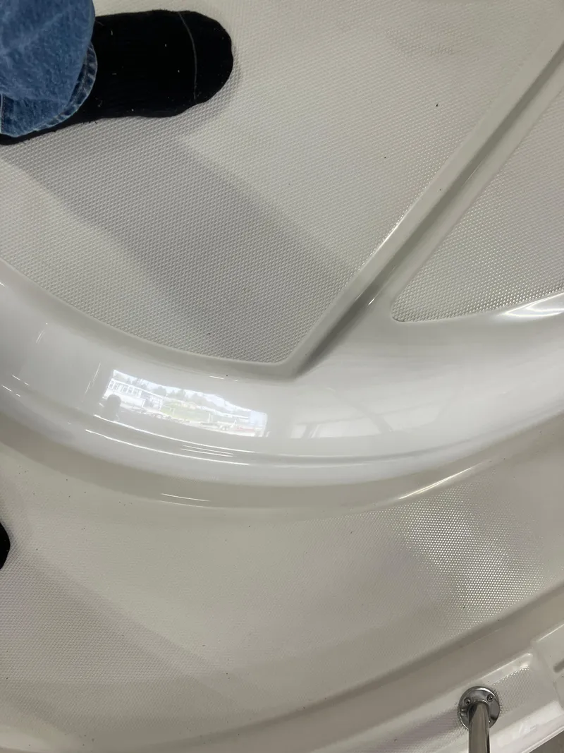 Slide: The Image of 2012 Striper 2901 Walkaround I/O boat deck with foot visible. - 7