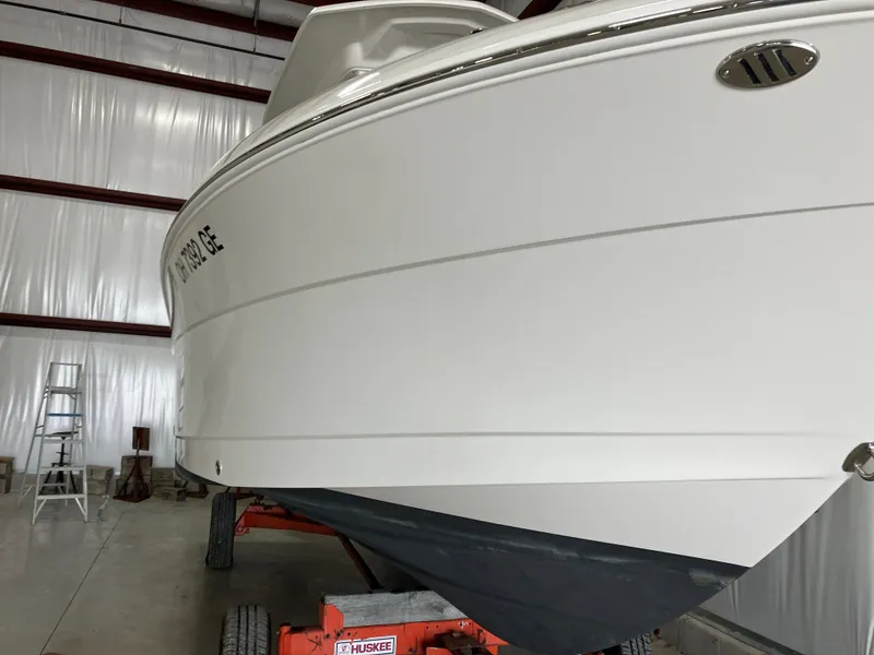 Slide: The Image of 2012 Striper 2901 Walkaround I/O boat in storage, side view. - 8