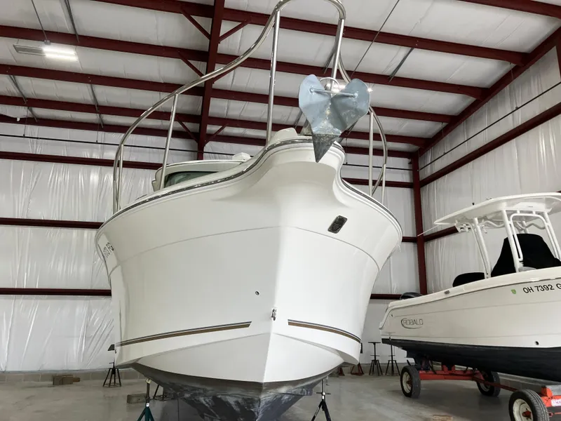 Slide: The Image of 2012 Striper 2901 Walkaround I/O boat in indoor storage facility. - 9
