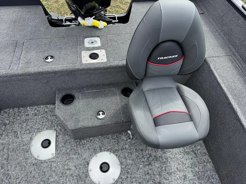 Slide: The Image of 2025 Tracker Pro Guide V-175 WT boat interior with gray seating and carpeted flooring. - 10