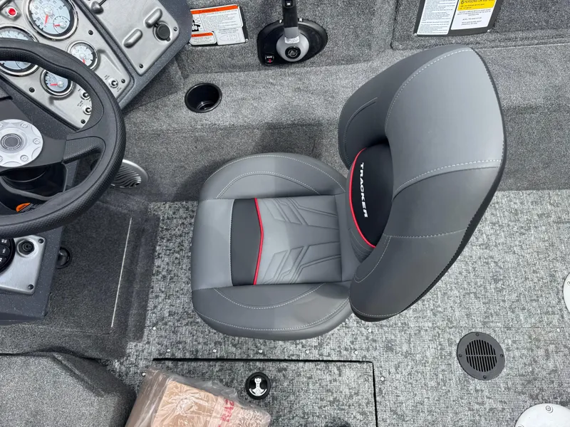 Slide: The Image of 2025 Tracker Pro Guide V-175 WT boat interior with gray seat and dashboard controls. - 13