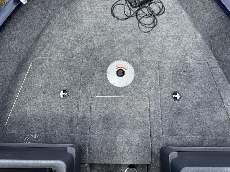 Slide: The Image of 2025 Tracker Pro Guide V-175 WT boat deck with gray carpet and storage compartments. - 16