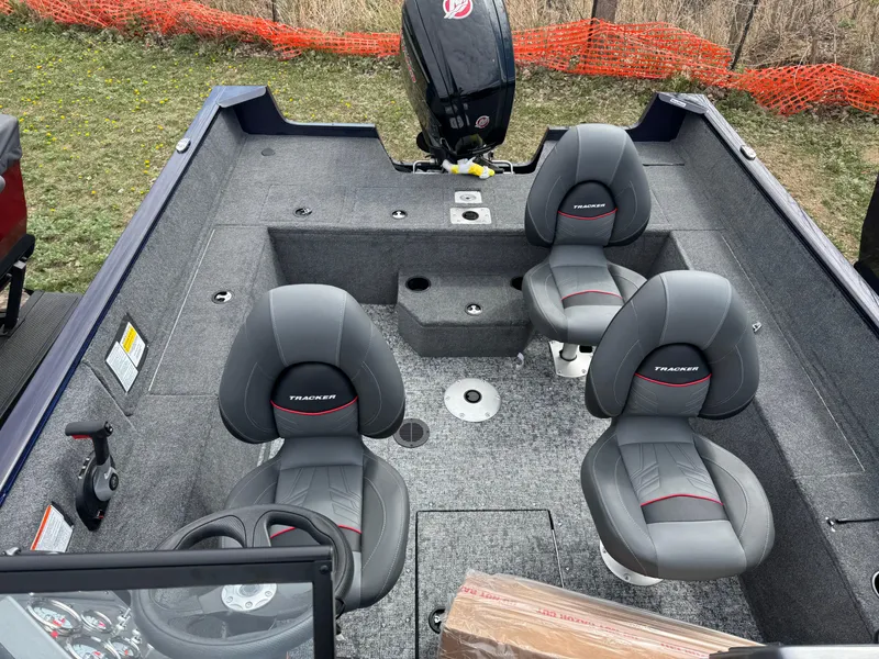 Slide: The Image of 2025 Tracker Pro Guide V-175 WT boat interior with gray seating and steering wheel. - 17