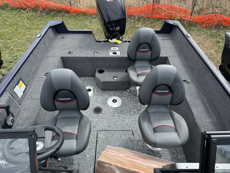 Slide: The Image of 2025 Tracker Pro Guide V-175 WT boat interior with four gray seats. - 20