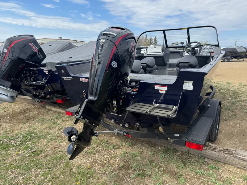 Slide: The Image of 2025 Tracker Pro Guide V-175 WT boat with dual outboard motors on a trailer. - 4