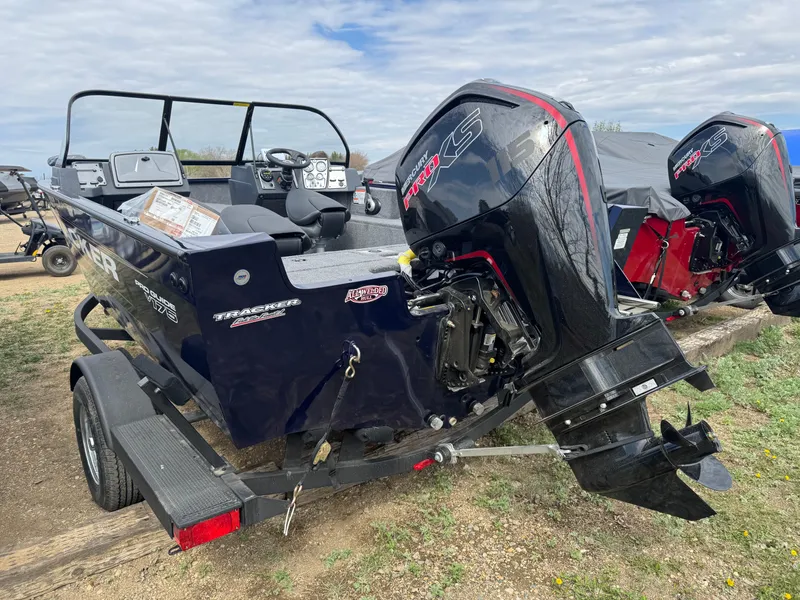 Slide: The Image of 2025 Tracker Pro Guide V-175 WT boat with dual outboard motors on a trailer. - 5