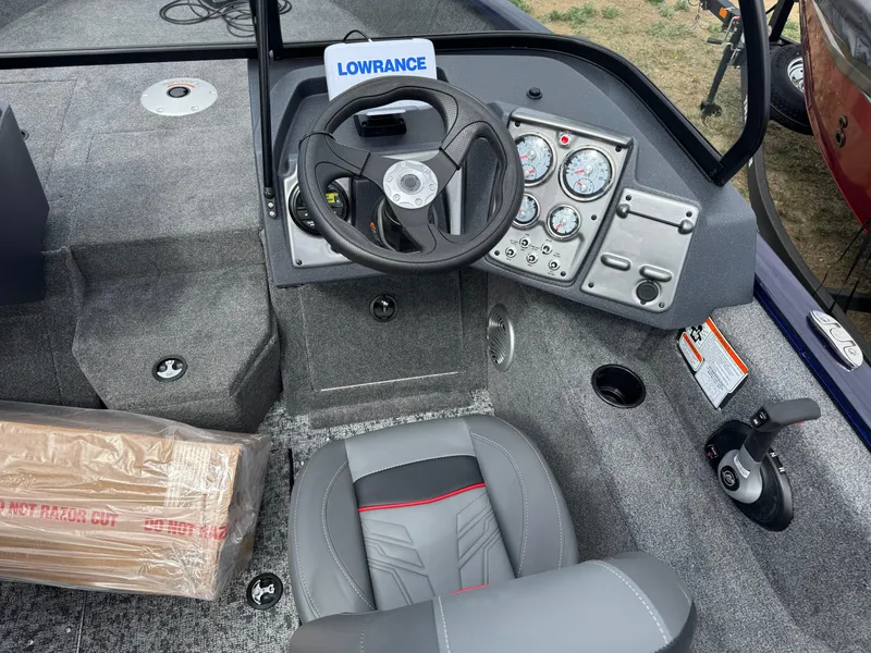 Slide: The Image of 2025 Tracker Pro Guide V-175 WT boat interior with steering wheel and control panel. - 6