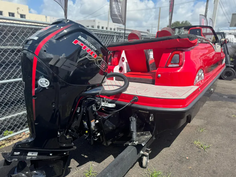 Slide: The Image of Red Fiat 500 Abarth boat with Mercury Pro XS engine, 2025 model, parked outdoors. - 11