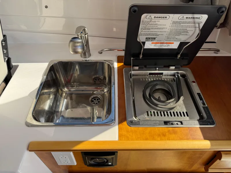 Slide: The Image of 2018 Cutwater C-242 Coupe kitchen with stainless steel sink and stove. - 12