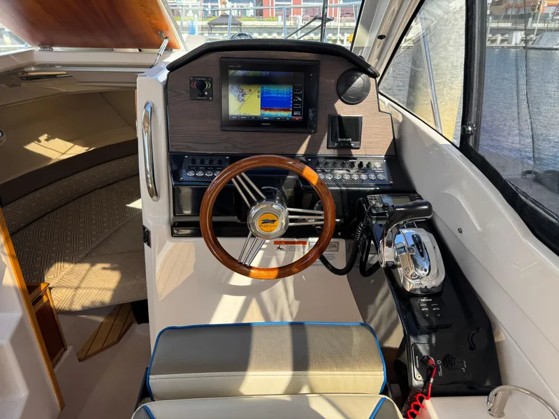 Slide: The Image of 2018 Cutwater C-242 Coupe helm with wooden steering wheel and navigation display. - 14