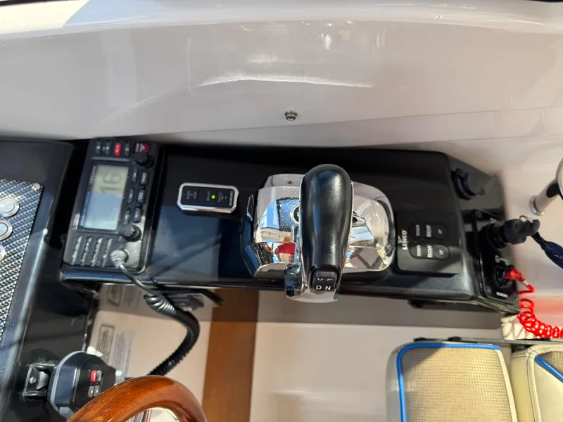 Slide: The Image of Control panel of a 2018 Cutwater C-242 Coupe boat with throttle and navigation instruments. - 15